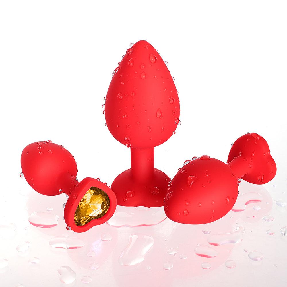 Gelbes Edelstein-Buttplug-Set aus rotem Silikon 